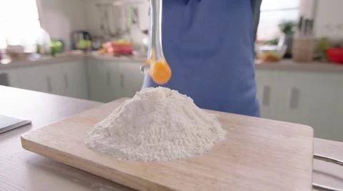 Egg falling into the flour Stock Footage 46458861