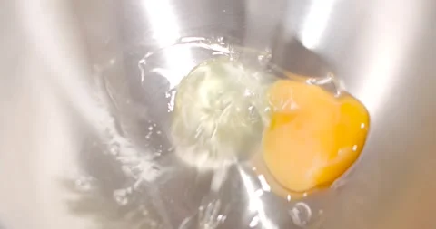 The egg falling into the metal bowl. Stock Footage 262668660