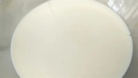 Egg falling in Milk in Slow Motion Video stock 129261426