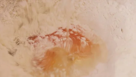 Egg falling into a pile of flour. Close up. Stock Footage 141450859