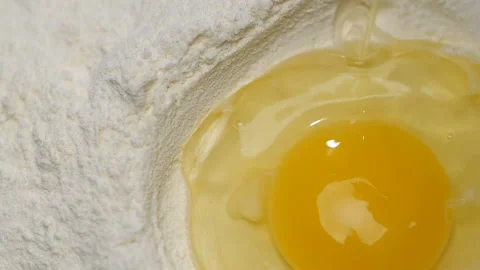 Egg falling into a pile of flour. Stock Footage 95709587