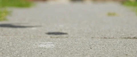 Egg falling on the road and breaking in slow motion Stock Footage 85800755