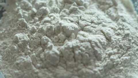 Egg falls into the flour close up Stock-Footage 135826596