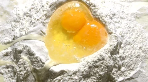Egg falls into flour. Video stock 60138477