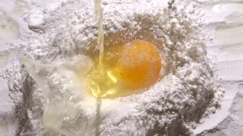 Egg falls into flour. Video stock 60138479