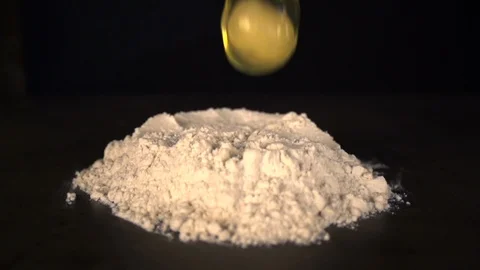 The egg falls into flour Stock Footage 93963175