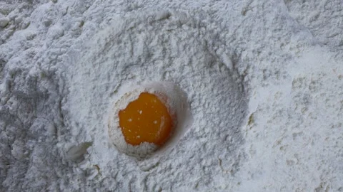 Egg Falls Into the Flour Stock Footage 249924014