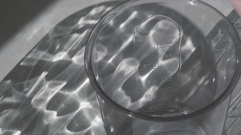 The egg falls into a measuring mug and whips up. Slow motion Stock Footage 75378264