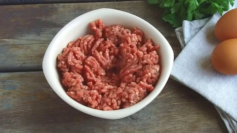 The egg falls into minced meat raw slow motion Stock Footage 79233511