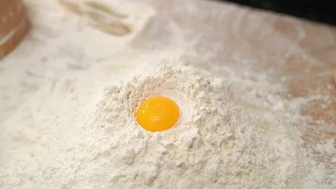 Egg Falls Into White Flour Stock Footage 273500371