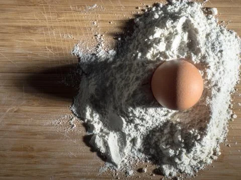 Egg on The Flour, ready for Bread an Cake, Artistic Light	 Stock Photos