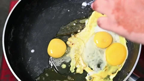 An egg is fried in a fry-pan. Cooking. slow motion video Stock Footage 203476449