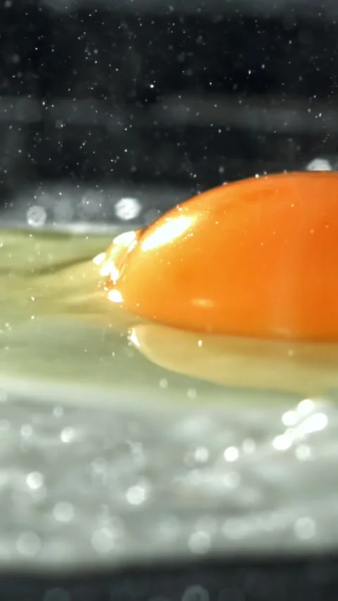 The egg is fried in a pan. Filmed on a high-speed camera at 1000 fps Stock Footage 335373286