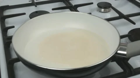 Egg fried in a pan with a white non-stick coating - quick breakfast Stock Footage 134309549