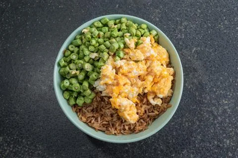 Egg fried rice and bean in green bowl on slate table. Stock Photos