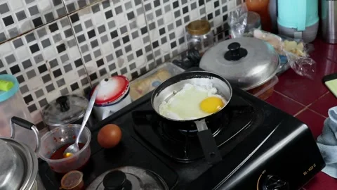 An egg is fried in a small frying pan Stock Footage 242570921