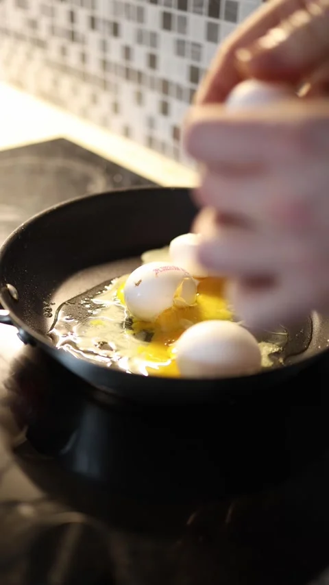 Egg frying mistake messy beginner cooking Stock Footage 329449399