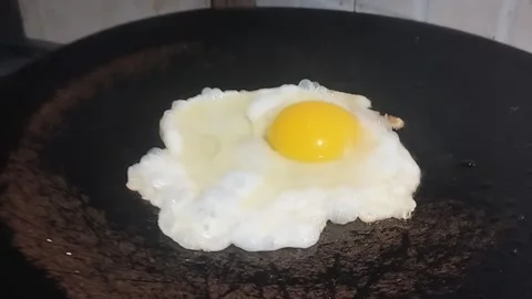 An Egg Frying on non stick pan Stock Footage 265153403