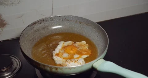 Egg frying in a pan Stock Footage 132708233