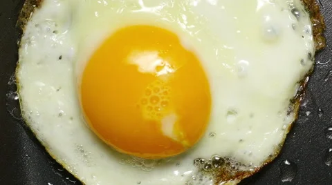 Egg in frying pan. Form of heart. Stock Footage 57303980