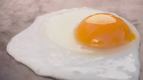 Egg frying on stone surface close up Stock Footage 309458855