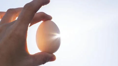 Egg in hand against the sky. easter Stock Photos