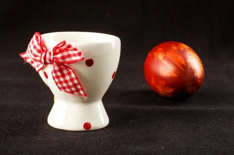 Egg holder and the painted Easter egg on the black background Stock Photos