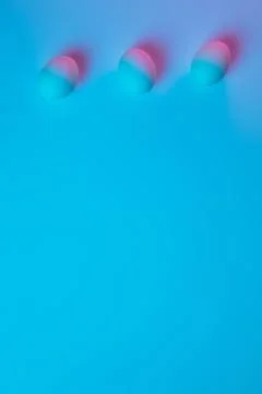 Egg hunt is coming. Easter traditions, neon colored eggs, top view Stock Photos
