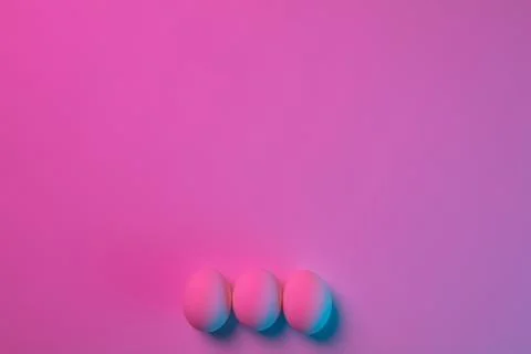 Egg hunt is coming. Easter traditions, neon colored eggs, top view Stock Photos