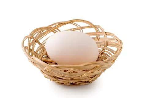 Egg lay in a woven basket Stock Photos