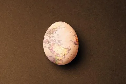 Egg with map texture on brown background. Stock-Fotos