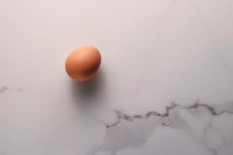 Egg on marble table as minimalistic food flat lay, top view food brand photog Stock Photos