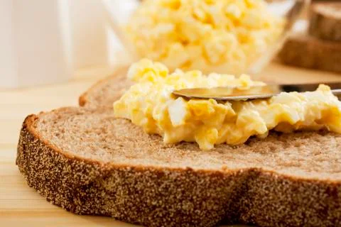 Egg mayonnaise being spread on bread Stock Photos