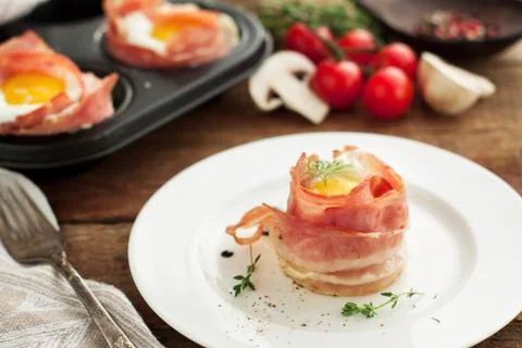 Egg muffins in crispy bacon Stock Photos