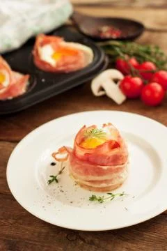 Egg muffins in crispy bacon Stock Photos