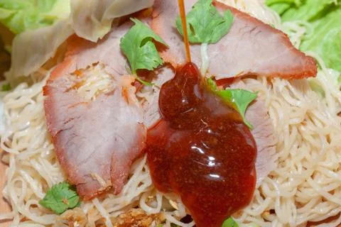 Egg noodle soup with red roasted pork and sauce Stock Photos