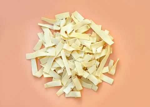 Egg noodles top view. Thin pasta on a orange background. Stock Photos