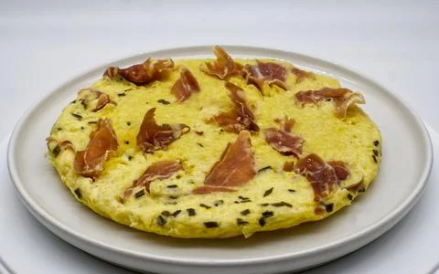 An egg omelette with ham on a white background Stock Photos