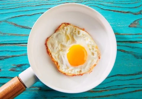 Egg over easy on white pan Stock Photos