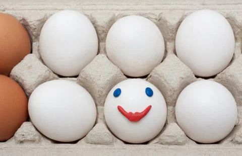 Egg in packing, smile Stock Photos