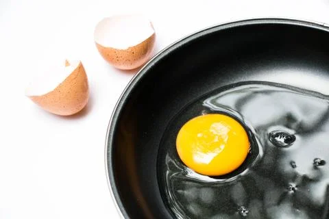 Egg in pan on white background Stock Photos