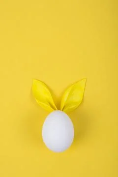 Egg with paper ears in the shape of an Easter bunny. Happy Easter Concept Car Stock Photos