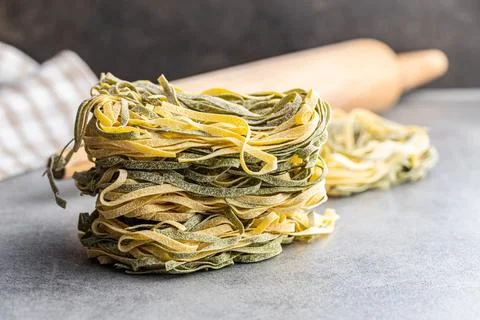 Egg pasta. Noodles nest with spinach flavor. Stock Photos