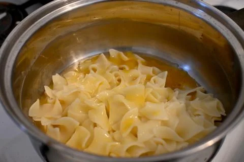 Egg pasta preparation in pot Stockfoto's