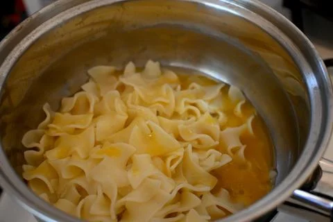 Egg pasta preparation in pot Photos