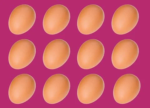 Egg pattern: raw chicken eggs on a purple background, one broken egg. Top vie Stock Photos