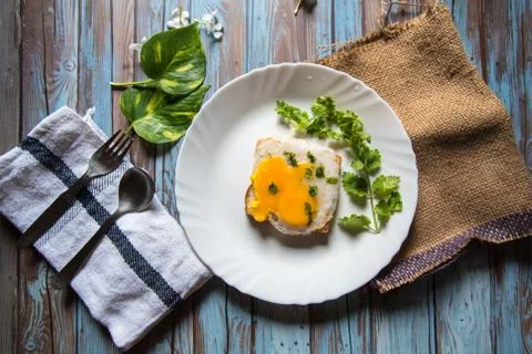 Egg poach on bread with condiments on a background Stock Photos