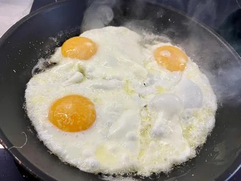 An egg is prepared in a pan for breakfast Stock Photos