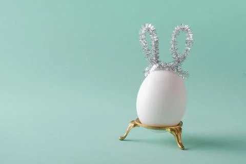 An egg with rabbit ears. happy Easter. Minimalism. Stock Photos