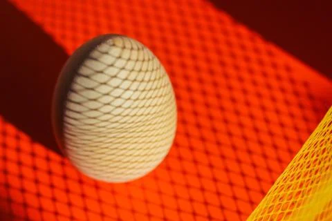 Egg on a red background with a shadow. creative Easter background Fotos de archivo